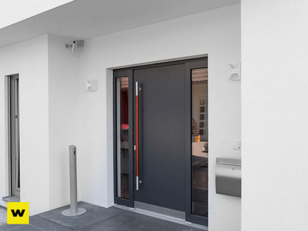 Moderne Haustür aus Aluminium mit Seitenteil in einem weißen Haus, sicher und stilvoll.